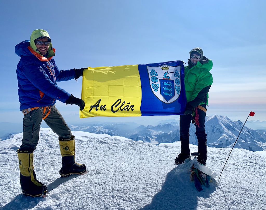 Katie McCaffrey and Porter Crockard on the summit of Denali (20,308') with the banner of County Clare, on the west coast of Ireland, where Katie's family is from.  (credit: Alaska Mountaineering School)
