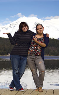Two students on the UAS Juneau campus dock enjoying the sunshine