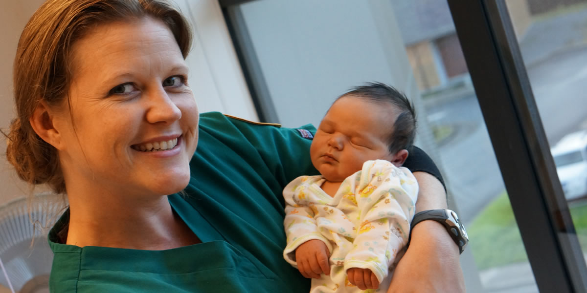 nursing student with baby