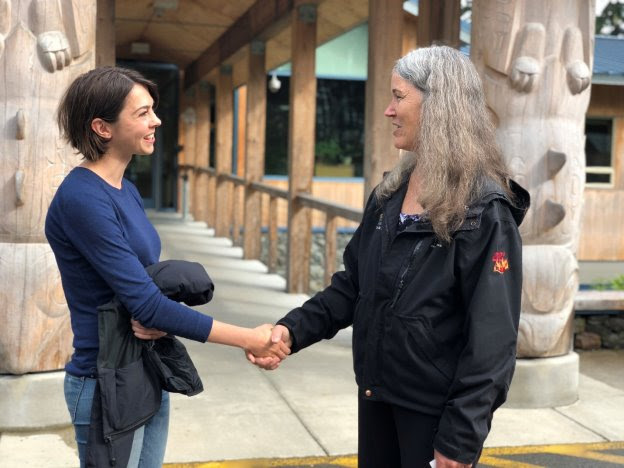 Student Mollie Dwyer shakes hands with Jan Trigg of Coeur Alaska